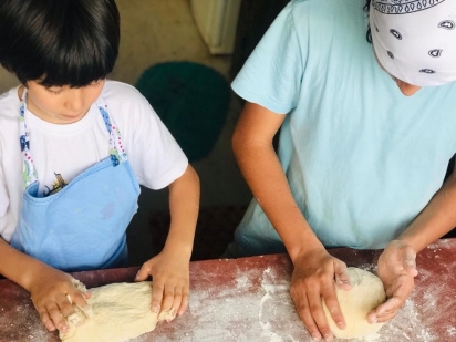 Raul ensinando a receita do pão para o irmão mais novo. (Foto: Arquivo Pessoal)